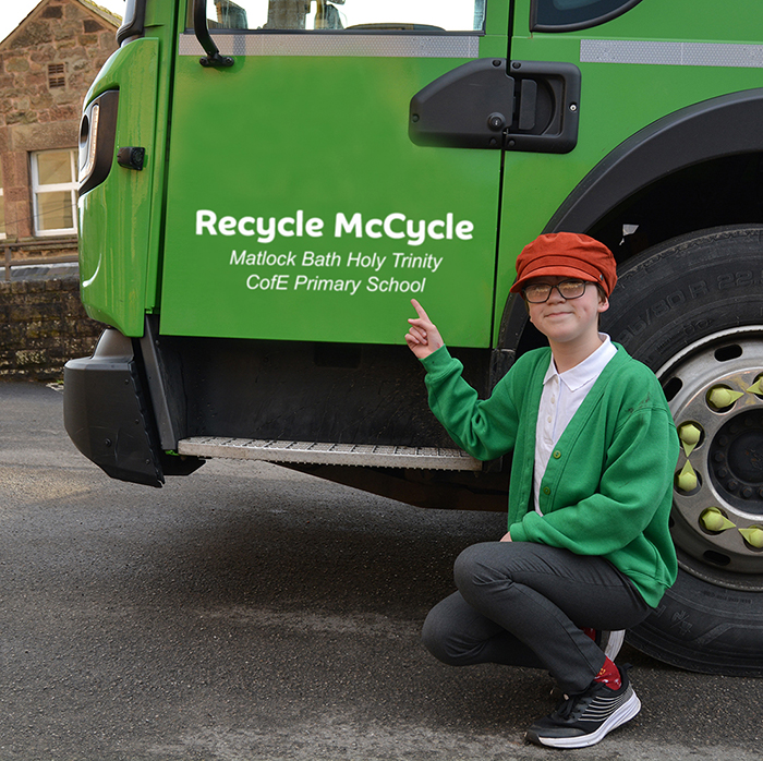 Bella representing Matlock Bath Primary, pointing to their Recycle McCycle truck name